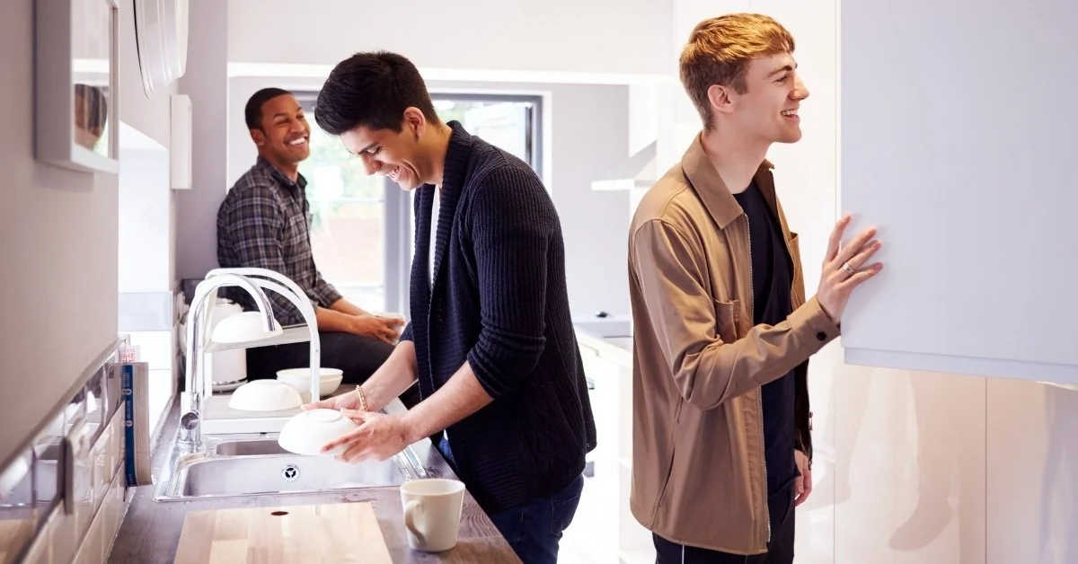 Group of male college students hanging out in shared kitchen